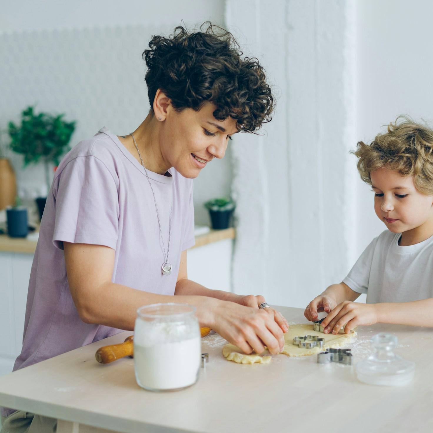 Community members collaborating in a contemporary kitchen, exchanging recipes and techniques